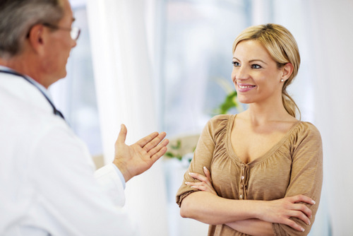 woman speaking with breast surgeon