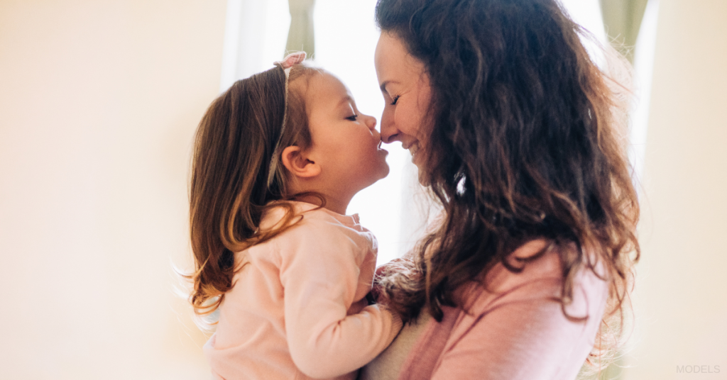 Mother holding her toddler (models)