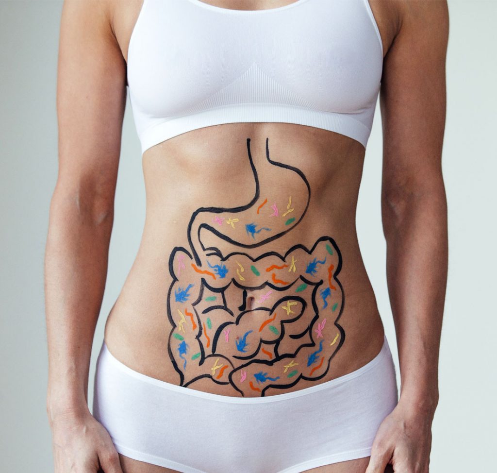 Woman with painted digestive diagram on her abdomen