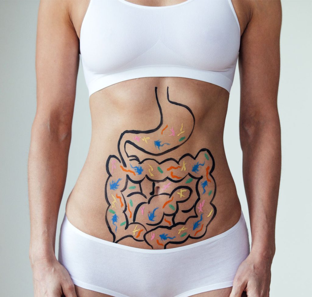 Woman with painted digestive diagram on her abdomen