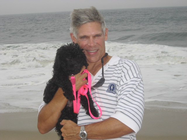 Dr. Parker holding Lulu on the beach