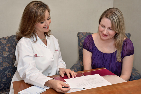 Angela reviewing papers with a patient