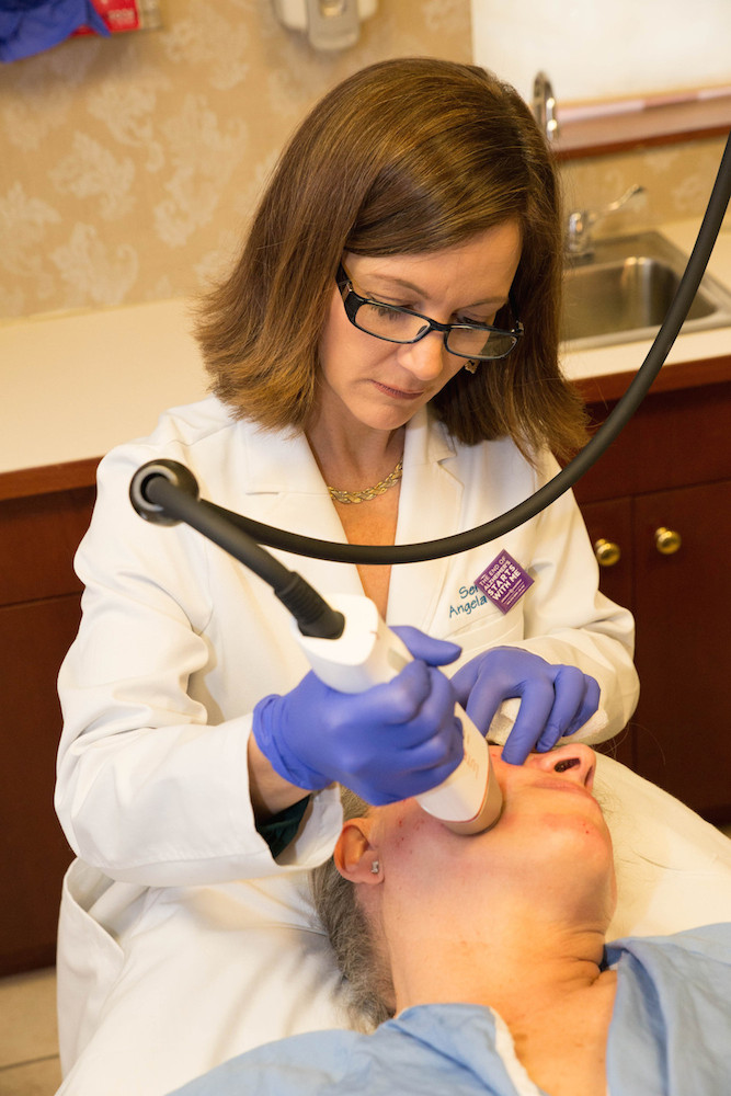 Nurse Angela performing the INFINI treatment on a patient\'s face