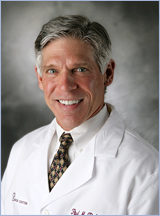 Headshot of Dr. Parker wearing a white labcoat