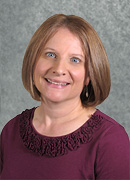 Headshot of Laurie Ann wearing a burgundy top