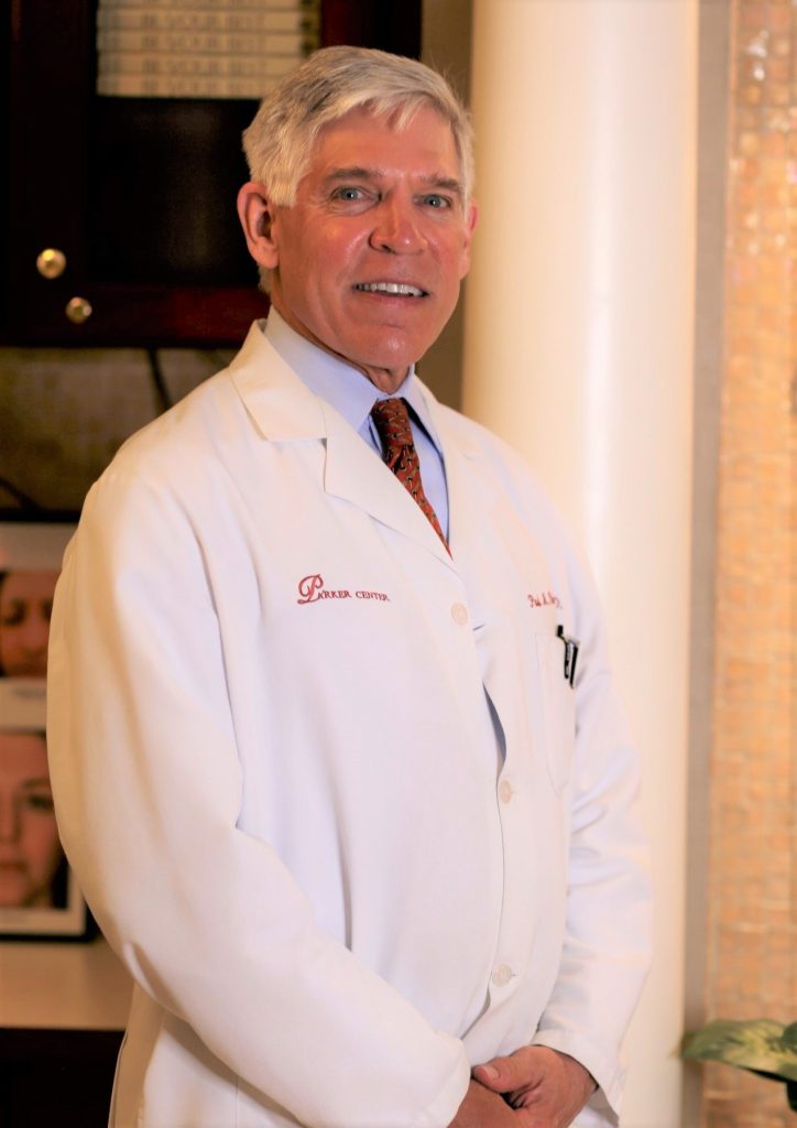 Dr. Parker smiling and wearing a white labcoat