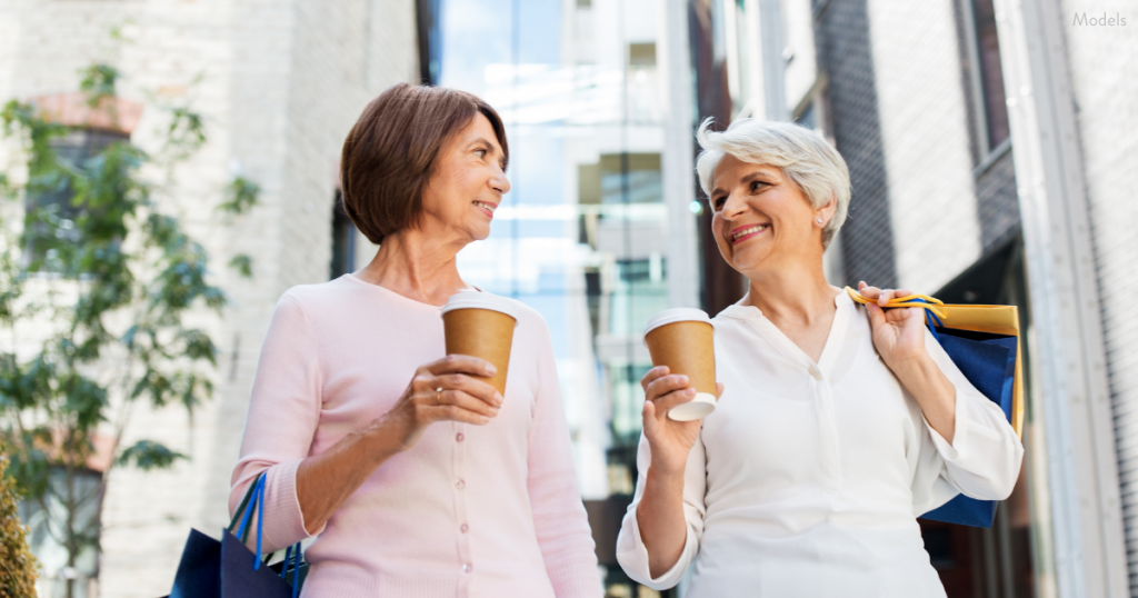 Two senior women walking and enjoying a cup of coffee near Paramus, NJ (models)