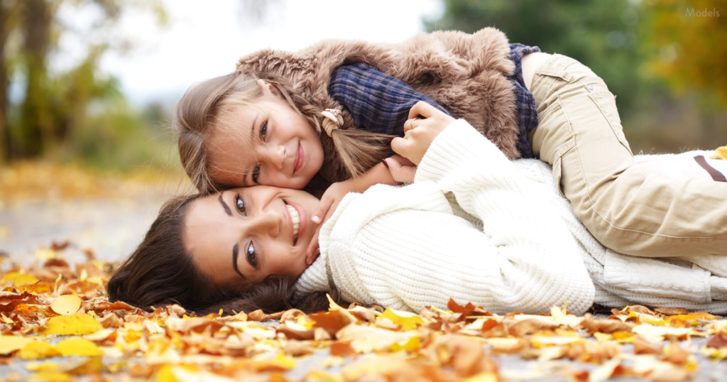 mother and child playing in the fall leaves in Paramus, NJ