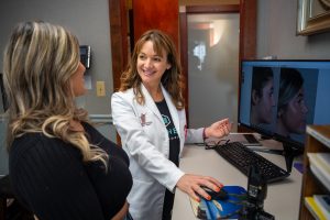 Angela Parker in lab coat giving consultation