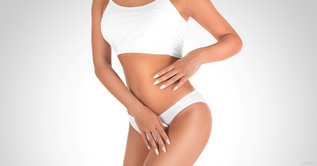 Woman in white lingerie with her hands on her body (model)